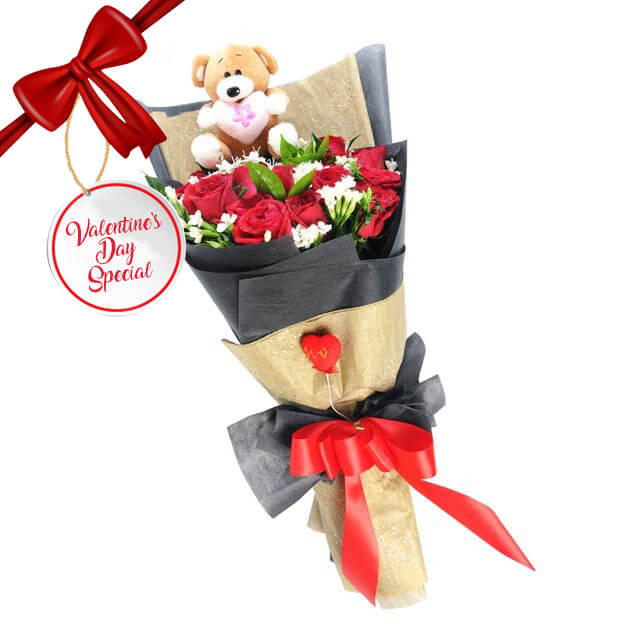 Cuteness at Play arrangement with 24 red roses and a small teddy bear