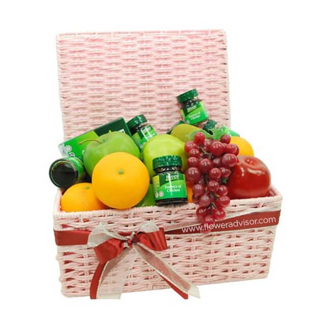 Pink hamper basket with assorted fresh fruits and six bottles of chicken essence, gift ribbon