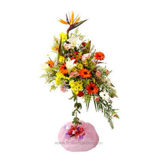 Colorful standing flower arrangement with lilies, Bird of Paradise, carnations, and daisies