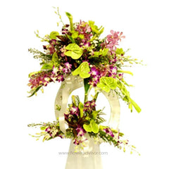 Orchid, calla lily, anthurium pompom flower arrangement in a modern white vase