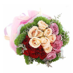 Vibrant hand bouquet with pink, red, and peach roses, green fillers, and pastel wrapping.