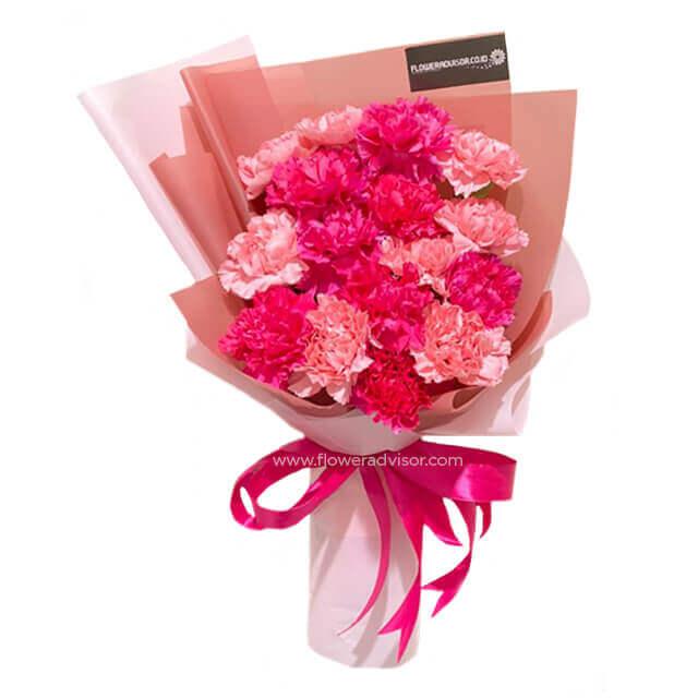 Bouquet of fresh pink and red carnations wrapped in pink paper with a pink ribbon, ideal for flower delivery in Kuala Lumpur