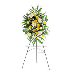 Standing floral arrangement with yellow and white flowers, green leaves on black metal tripod