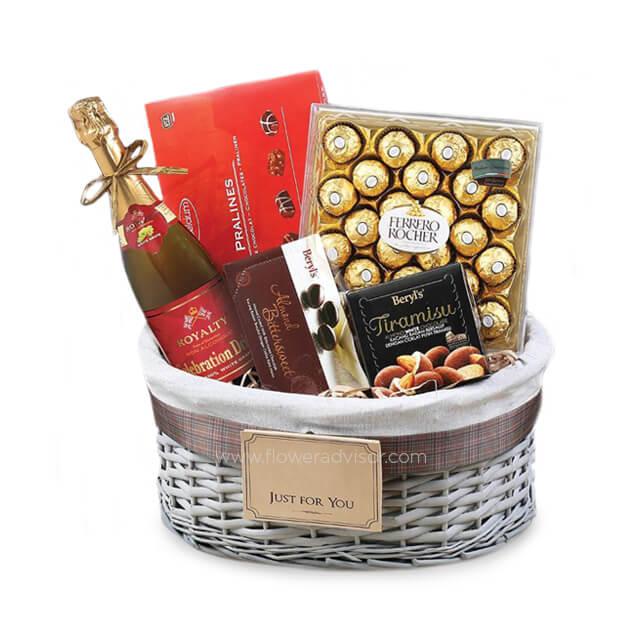 Gift basket with sparkling wine, Ferrero Rocher chocolates, pralines, and Beryl's Tiramisu chocolate box