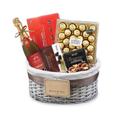 Gift basket with sparkling wine, Ferrero Rocher chocolates, pralines, and Beryl's Tiramisu chocolate box