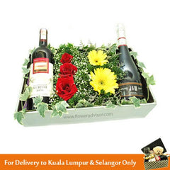 FlowerAdvisor Malaysia gift set with red wine, champagne, red roses, yellow daisies, and greenery in a decorative box for delivery in Kuala Lumpur and Selangor