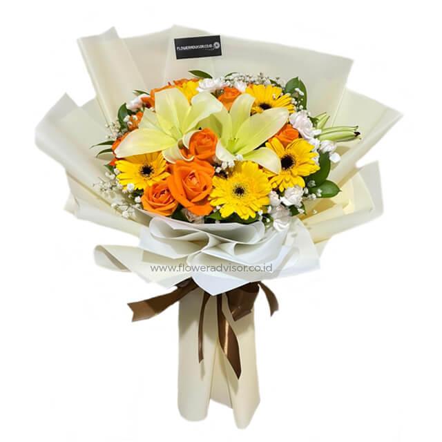Bright bouquet with orange roses, yellow lilies and gerbera, wrapped in white paper with brown ribbon