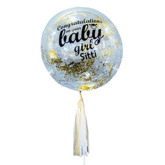 Clear round balloon with gold confetti and text congratulating baby girl Sitti, celebrating newborn with tassel