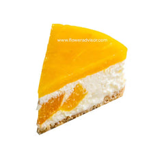 Slice of orange mango cheesecake with creamy filling and fruit topping on white background