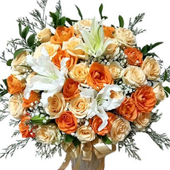 Elegant bouquet of orange and cream roses with white lilies and green foliage, fresh flower delivery