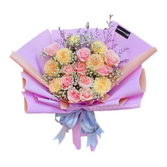 Elegant bouquet with pink roses, yellow chrysanthemums, and baby's breath wrapped in purple paper, tied with ribbon