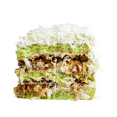 Close-up of layered green pandan cake slice with creamy coconut and textured filling