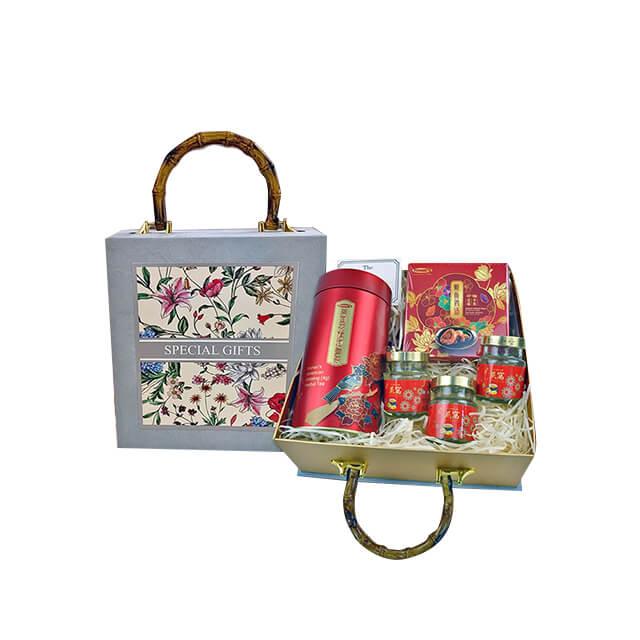 Elegant gift box with bamboo handle containing red-themed jars, a tin, and a decorative packet, FlowerAdvisor Malaysia