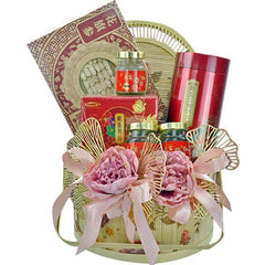 Elegant gift hamper with traditional Chinese herbs, red packaging, pink flowers, and gold decorative elements