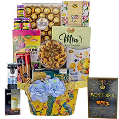 FlowerAdvisor Malaysia gift hamper with Ferrero Rocher chocolates, prune extract, cookies, fruit candy, and decorative blue flowers