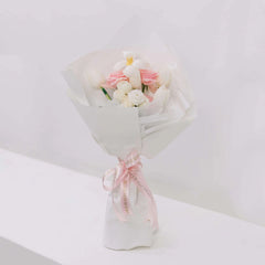 Elegant bouquet with white tulips, pink roses, and white flowers wrapped in white paper with pink FlowerAdvisor ribbon