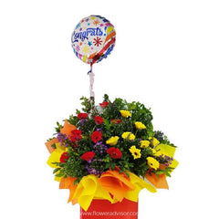 Colorful congrats bouquet with red, yellow, and purple flowers in orange and yellow wrapping with a 'Congrats!' balloon