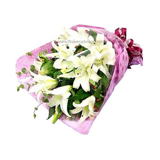 Elegant bouquet of fresh white lilies wrapped in pink floral paper with green foliage, ideal for flower delivery