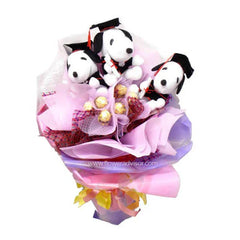 Bouquet with three Snoopy plush toys wearing graduation caps and wrapped chocolates, pink and purple floral wrapping