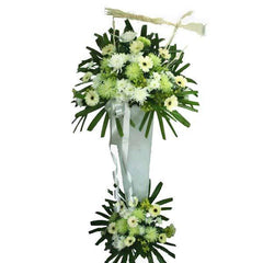 Elegant white and green condolence flower stand with chrysanthemums and gerberas