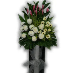 Standing flower arrangement with white chrysanthemums, pink ginger flowers, and greenery.
