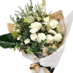 Mixed bouquet with 10 white roses, assorted white flowers, and green foliage in wrapping