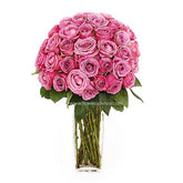 Bouquet of fresh pink roses arranged in a clear glass vase, ideal for flower delivery