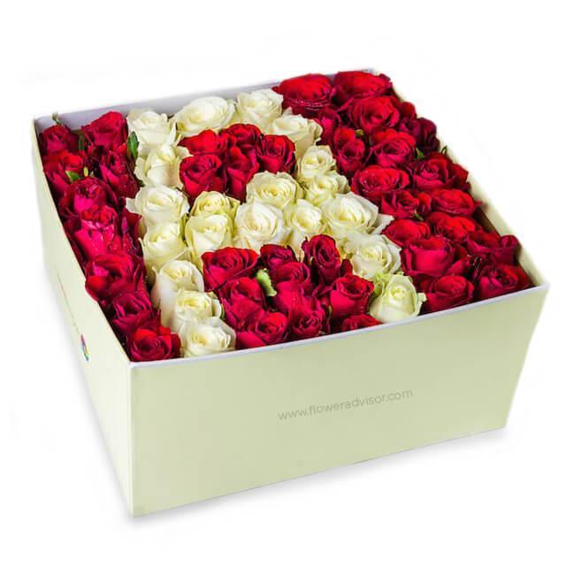 Box of fresh red and white roses arranged in a heart shape, perfect for flower delivery gift.