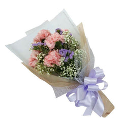 Hand-tied bouquet with pink carnations, purple statice, baby's breath, and lilac ribbon