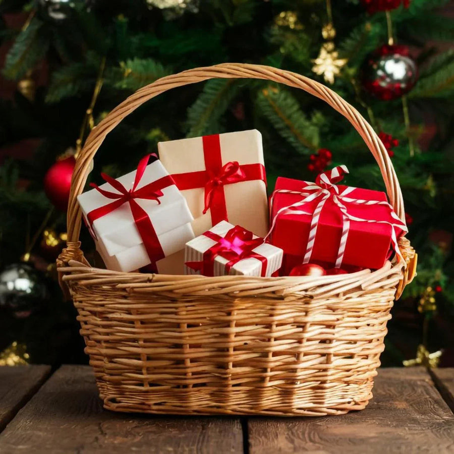 Christmas gift basket with red and white wrapped presents against decorated Christmas tree