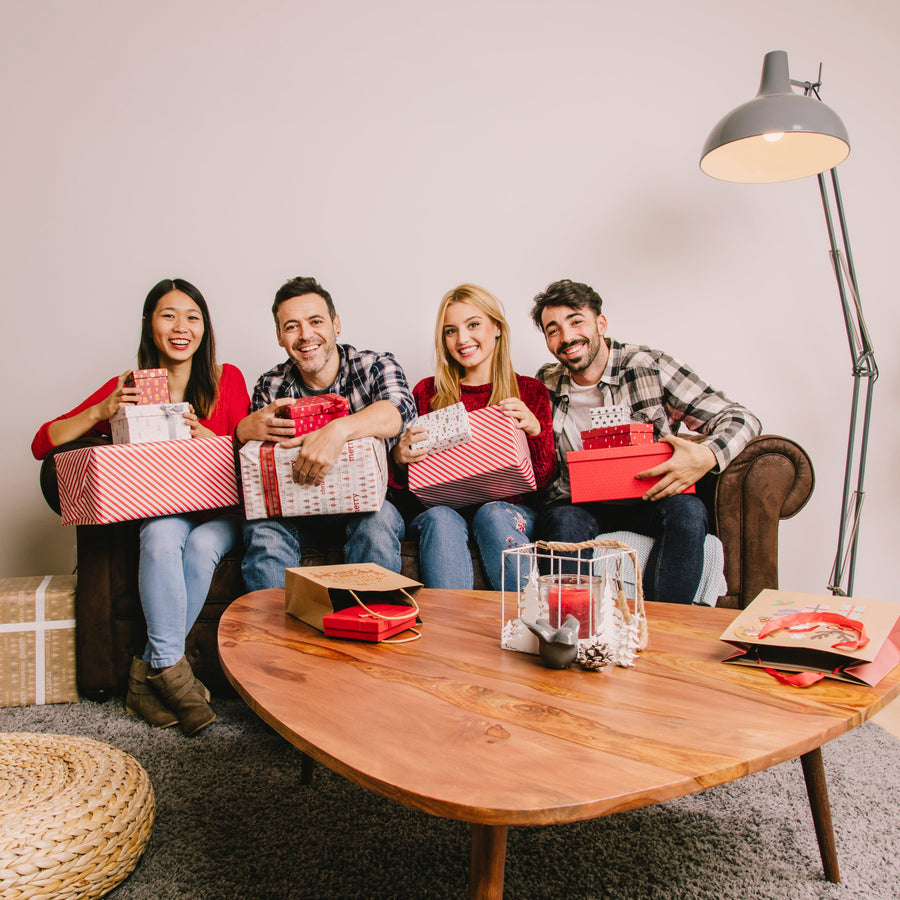 Best friends exchanging Valentine’s gifts while sitting together