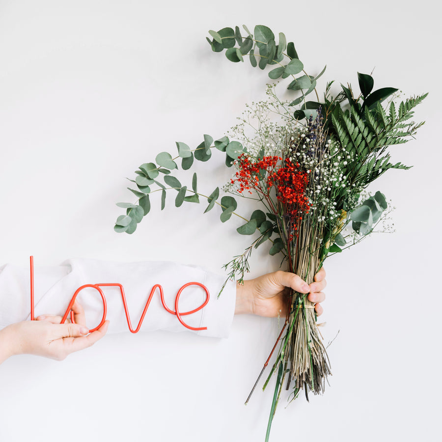 Hand holding allergy-friendly wildflowers for Valentine’s Day in Malaysia
