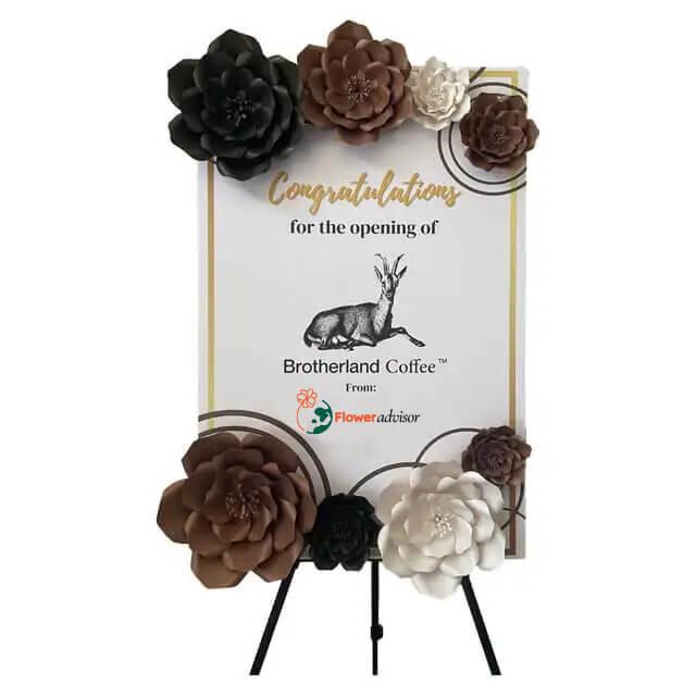 Congratulatory floral display stand with brown, black, and white flowers for Brotherland Coffee opening by FlowerAdvisor