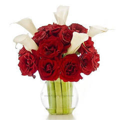 Bouquet of 18 red roses and 5 white lilies arranged in a clear glass vase