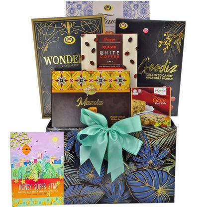 Gift hamper with assorted chocolates, coffee, cookies, and classic fruit cake in decorative box with teal ribbon