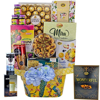FlowerAdvisor Malaysia gift hamper with Ferrero Rocher chocolates, prune extract, cookies, fruit candy, and decorative blue flowers