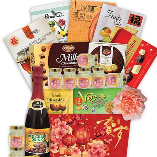 Luxury festive hamper with biscuits, chocolates, assorted snacks, red grape drink and flower