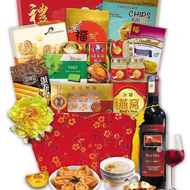 Chinese New Year hamper with festive treats, bird's nest, wine, and golden floral decor