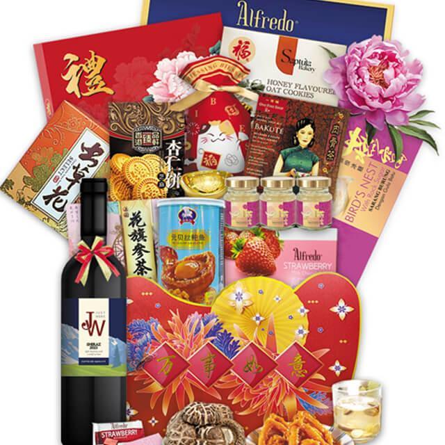 Chinese New Year festive hamper with wine, snacks, cookies, tea, bird's nest, and decorative flowers