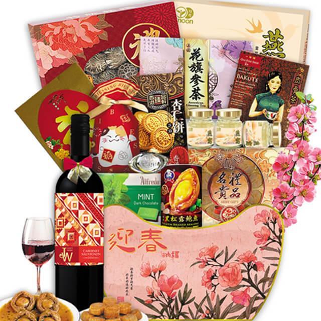 Chinese New Year gift hamper with wine, assorted snacks, tea, cookies, and festive packaging