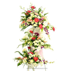 Fresh flower stand with anthurium, carnations, daisies, and greenery arrangement