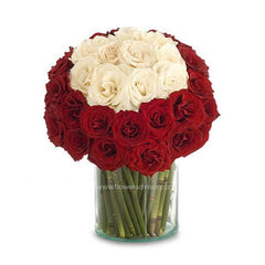 Elegant bouquet of red and white roses arranged in a clear glass vase.