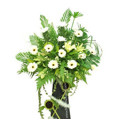 White chrysanthemums, lilies, sunflowers, and lush green leaves floral arrangement